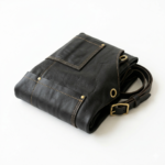 Folded black leather apron showing stitching and texture