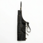 Side view of black leather apron showing strap design